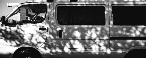 Black and white photo of a work van